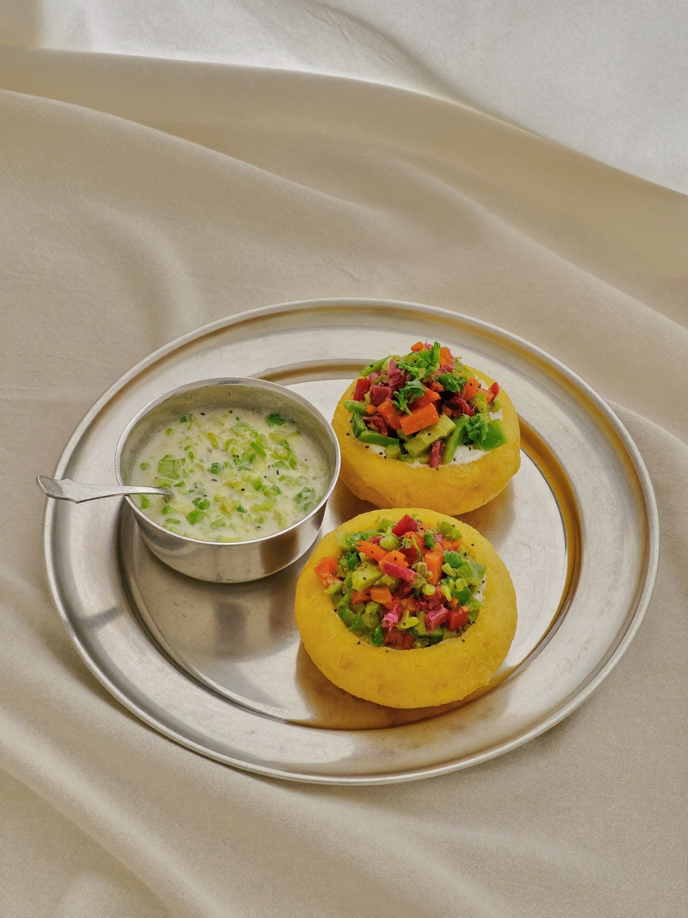 Two appam with a bowl of white coconut milk stew