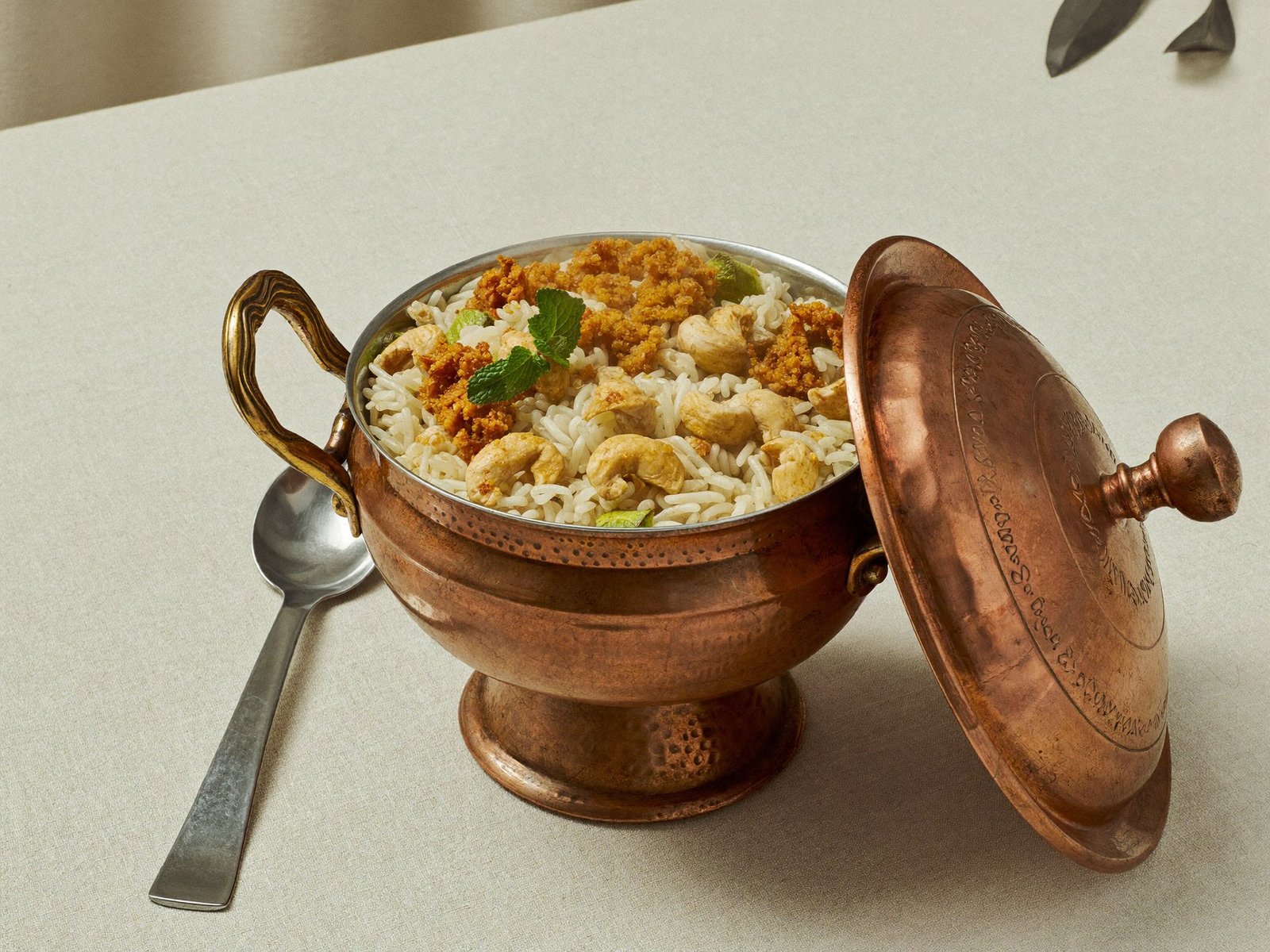Malabar dum biryani served in an open copper vessel